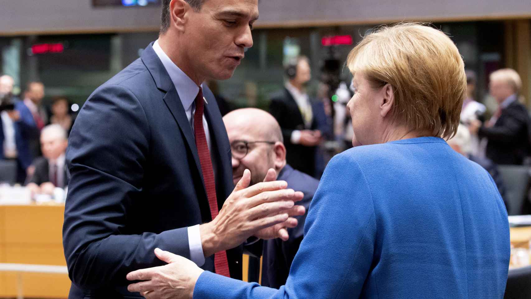 Pedro Sánchez conversa con Angela Merkel durante un Consejo Europeo, ante el presidente, Charles Michel.