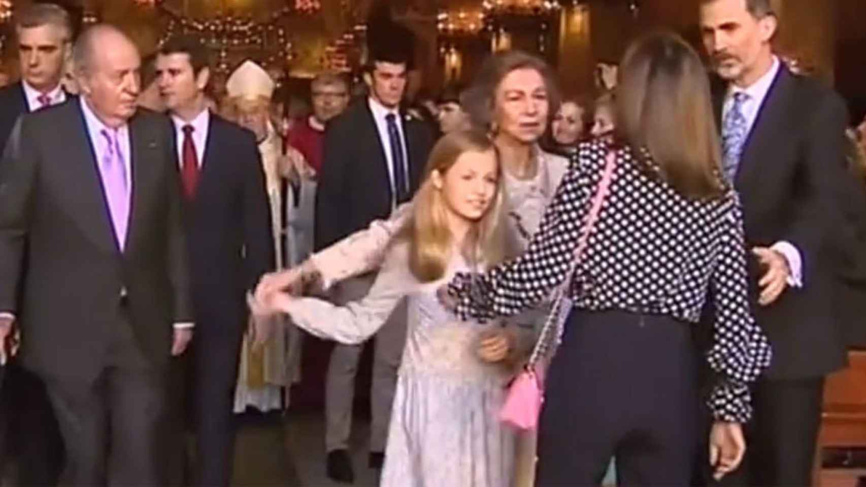Momento en el que la reina Letizia intenta evitar que Dofía se eche una foto con sus nietas.