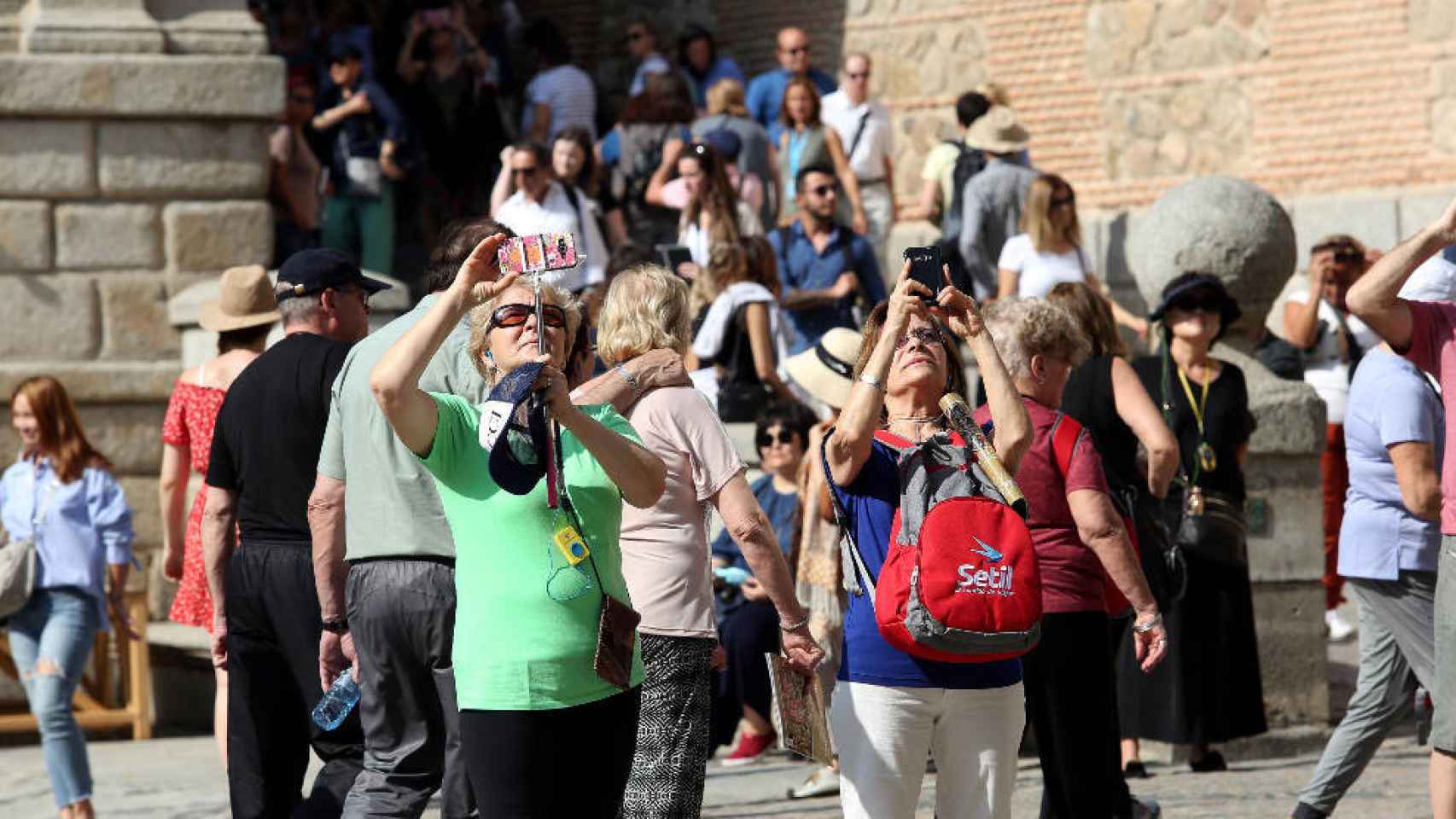 Varios turistas hacen fotos en la Plaza del Ayuntamiento de Toledo
