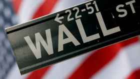 FILE PHOTO: A street sign is seen in front of the New York Stock Exchange on Wall Street in New York