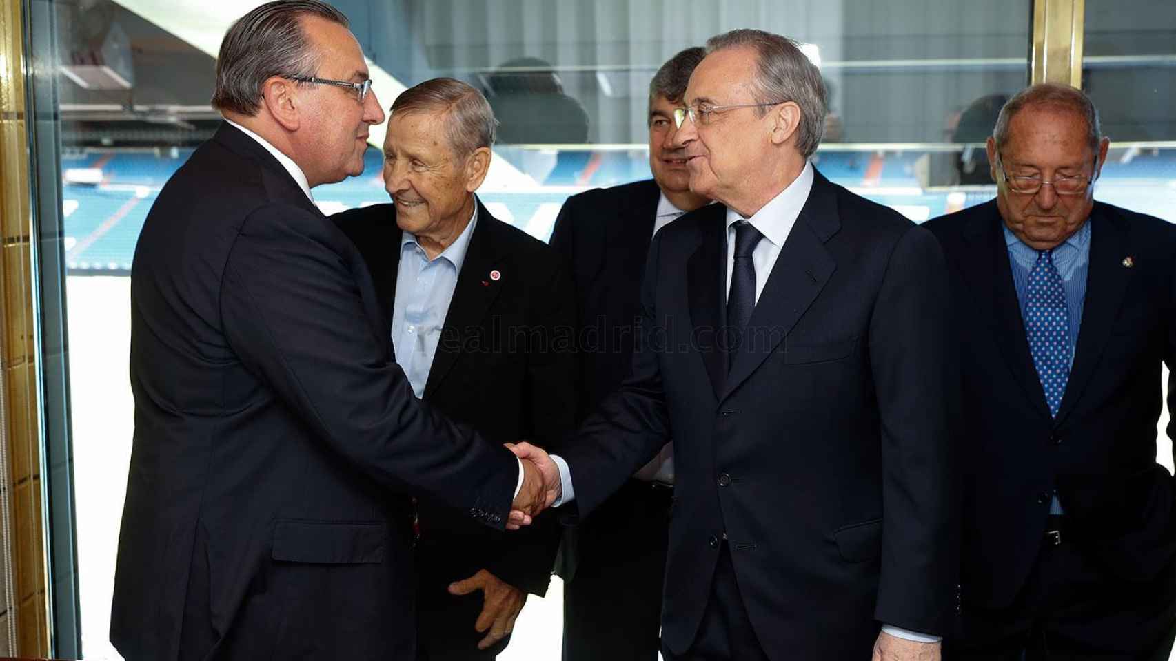 Florentino Pérez se saluda con Jean-Pierre Caillot