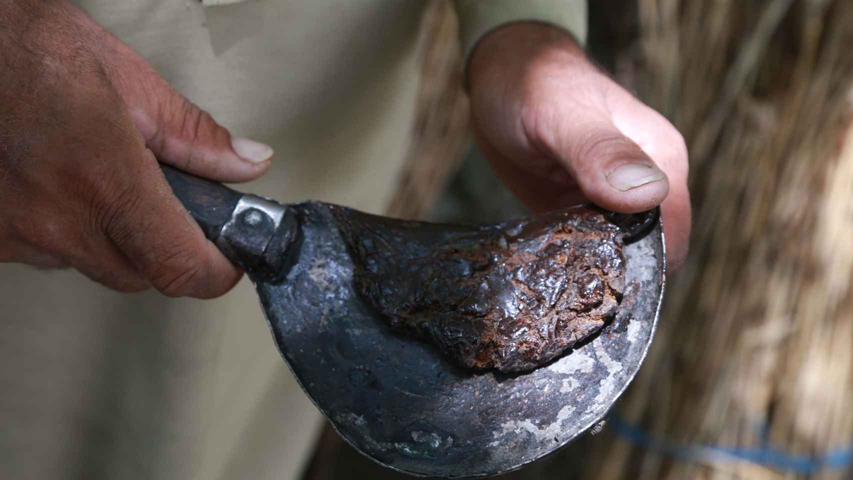 Agricultores extraen opio (heroína cruda) de los capullos de amapola y los conservan en el distrito de Khogyani.