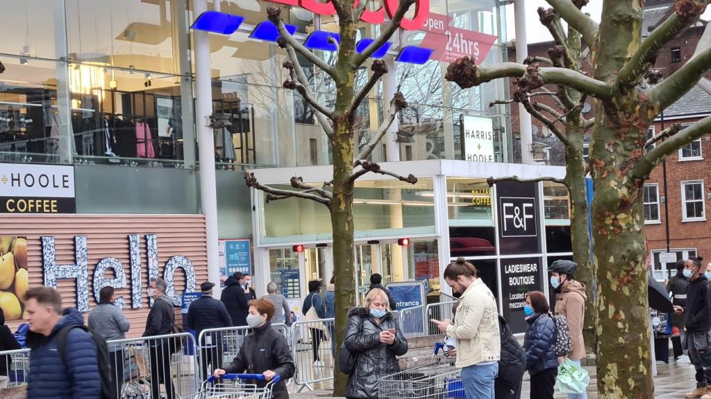 Personas haciendo cola en Londres a las afueras de un supermercado Tesco.
