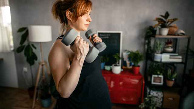 Una mujer embarazada, haciendo un ejercicio de fuerza.