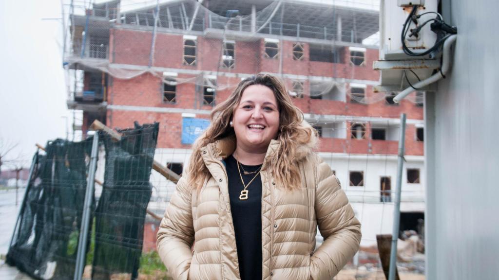 Bárbara Argüelles, dueña de la promotora PJR. De fondo, el edificio que está construyendo en Lugones (Asturias).