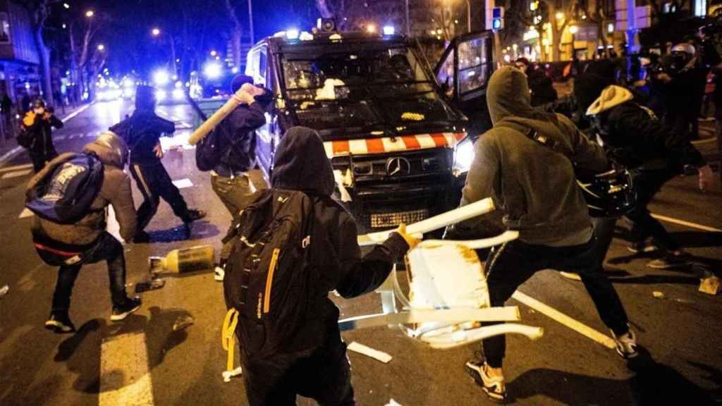 Cualquier objeto es bueno para golpear el furgón policial en Barcelona
