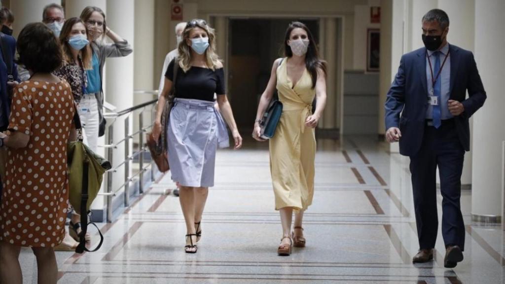 Yolanda Díaz, a la izquierda, camina junto a Irene Montero, a la derecha.