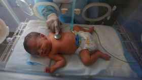Un recién nacido siendo atendido en la cuna de un hospital.