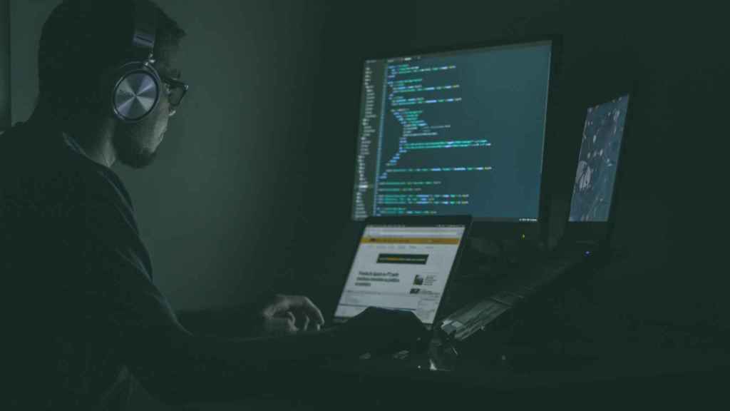 Un hacker usando varias pantallas.
