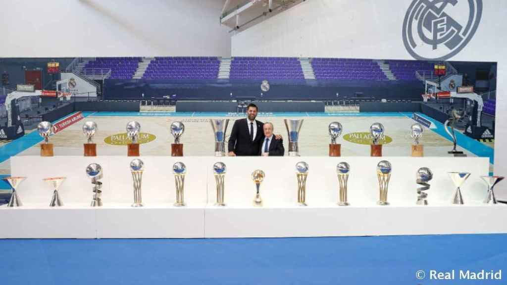 Felipe Reyes y Florentino Pérez junto a los trofeos del capitán