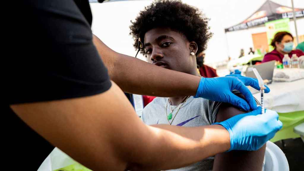 Un joven estadounidense recibe la vacuna contra la Covid-19 en Crenshaw, California.