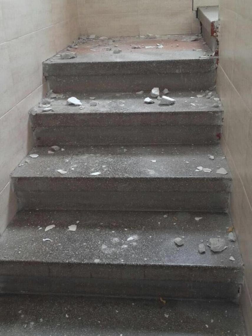 Restos de escombros caídos en la escalera de uno de los edificios de Carranque.