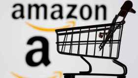 Small toy shopping cart is seen in front of displayed Amazon logo in this illustration