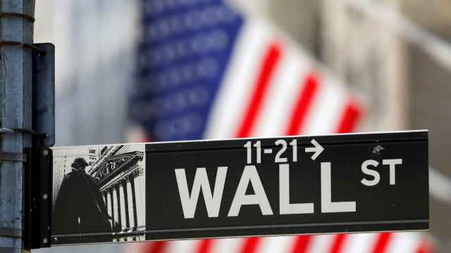 FILE PHOTO: A street sign for Wall Street is seen outside the New York Stock Exchange (NYSE) in New York City