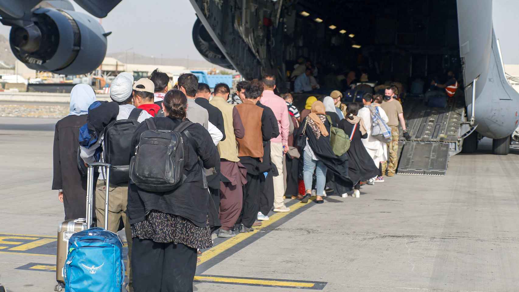 Refugiados afganos son evacuados de su país en un avión estadounidense.