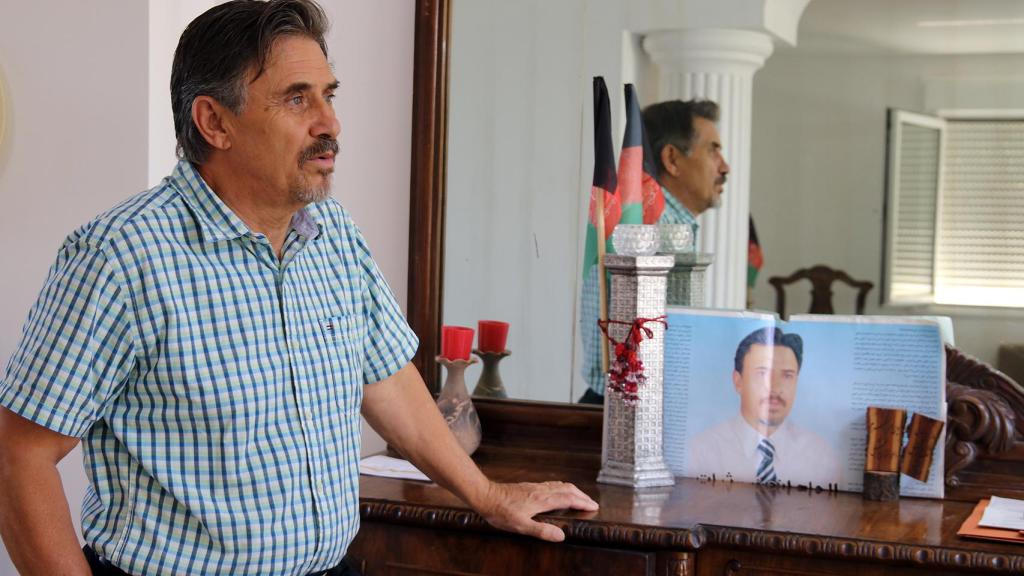 Subot Kohi junto a un cartel electoral de su etapa como diputado en el Parlamento de Afganistán.