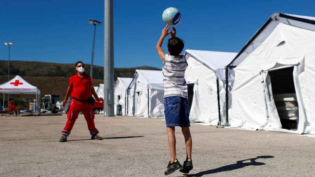 Afghan children play ball at the Red Cross camp in Avezzano, Italy.