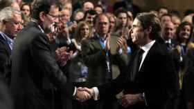 Mariano Rajoy y José María Aznar se saludan en la convención del PP, en 2015.