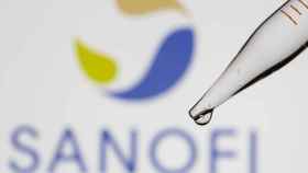 A test tube is seen in front of a displayed Sanofi logo in this illustration