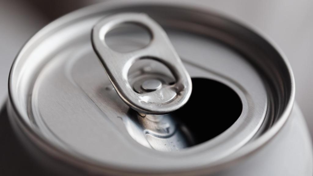 A soda can is a metal container and is deposited in the yellow container