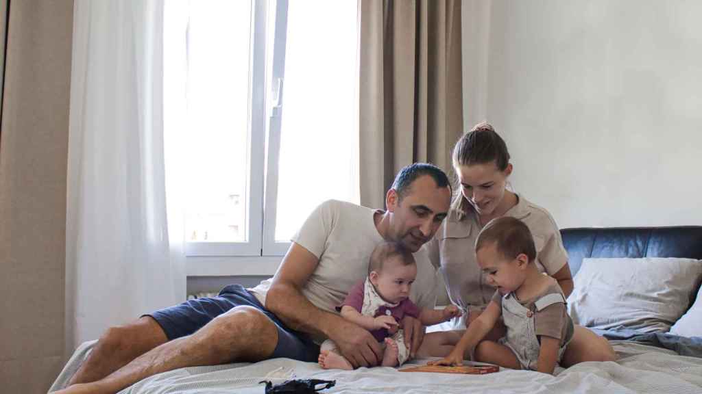 Nurettin Acar with his wife, Anna, and their children, Dara and Liya, at their home in Madrid.