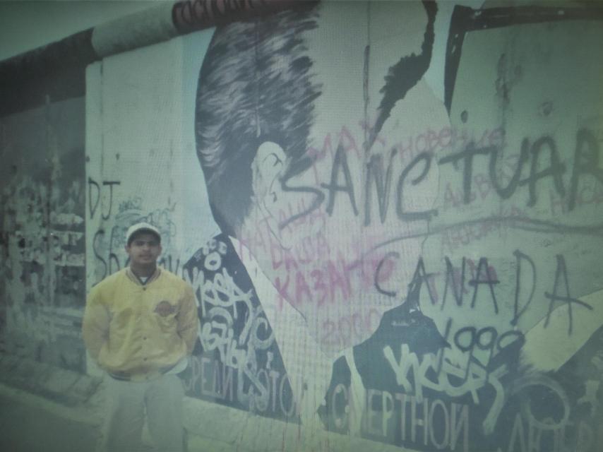 Oliver, on one of his many youth trips, at the Berlin Wall.