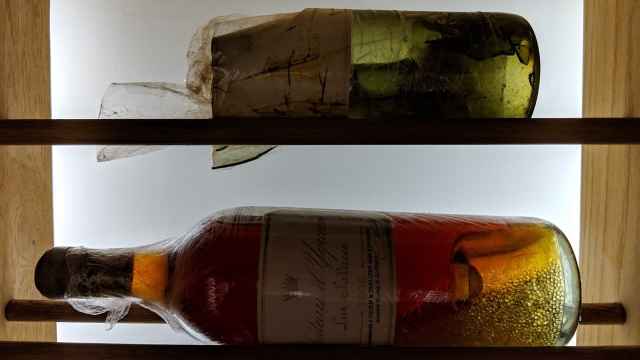 La botella original que se rompió y la botella recorchada que contiene el vino de la original