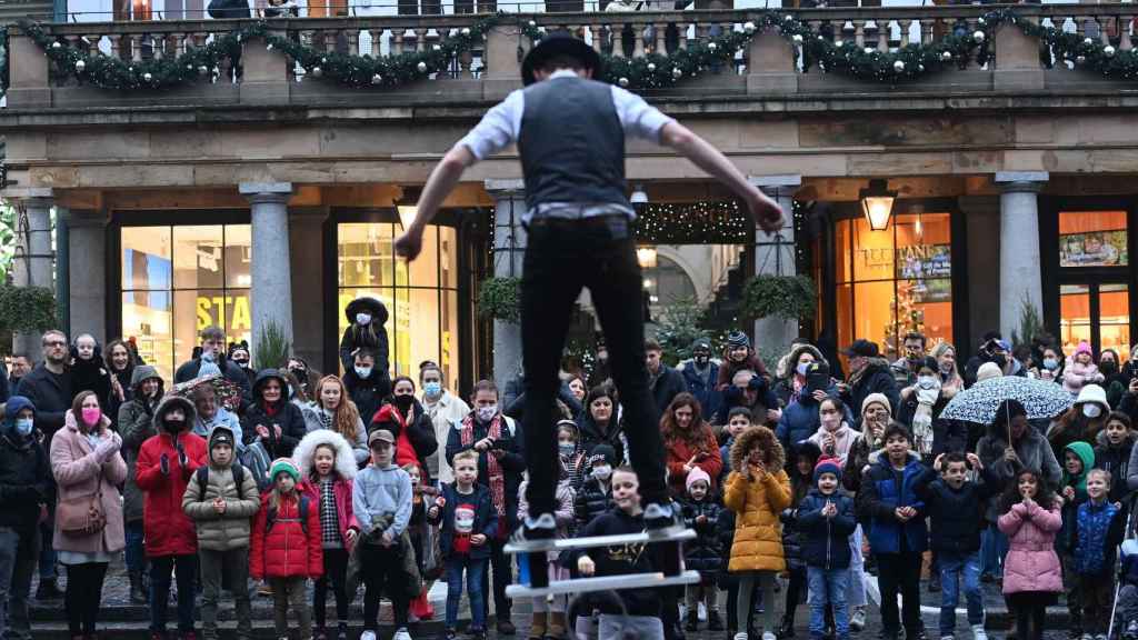 Ciudadanos disfrutan de un espectáculo navideño en las calles de Londres.