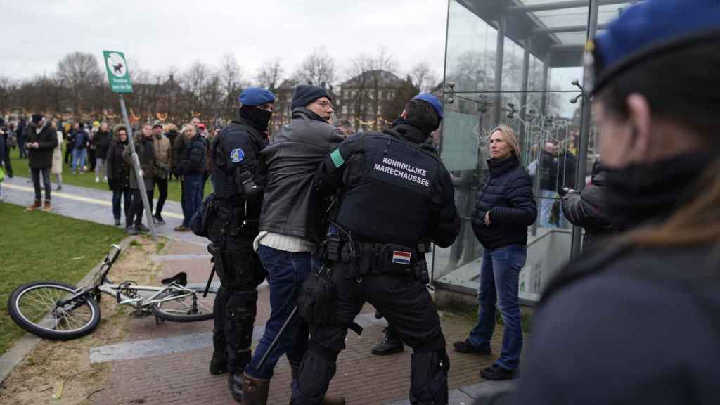 Un policía neerlandés agarra a un manifestante este domingo en Ámsterdam.