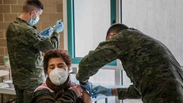 Dos soldados del Ejército de Tierra inoculando la vacuna a una paciente.