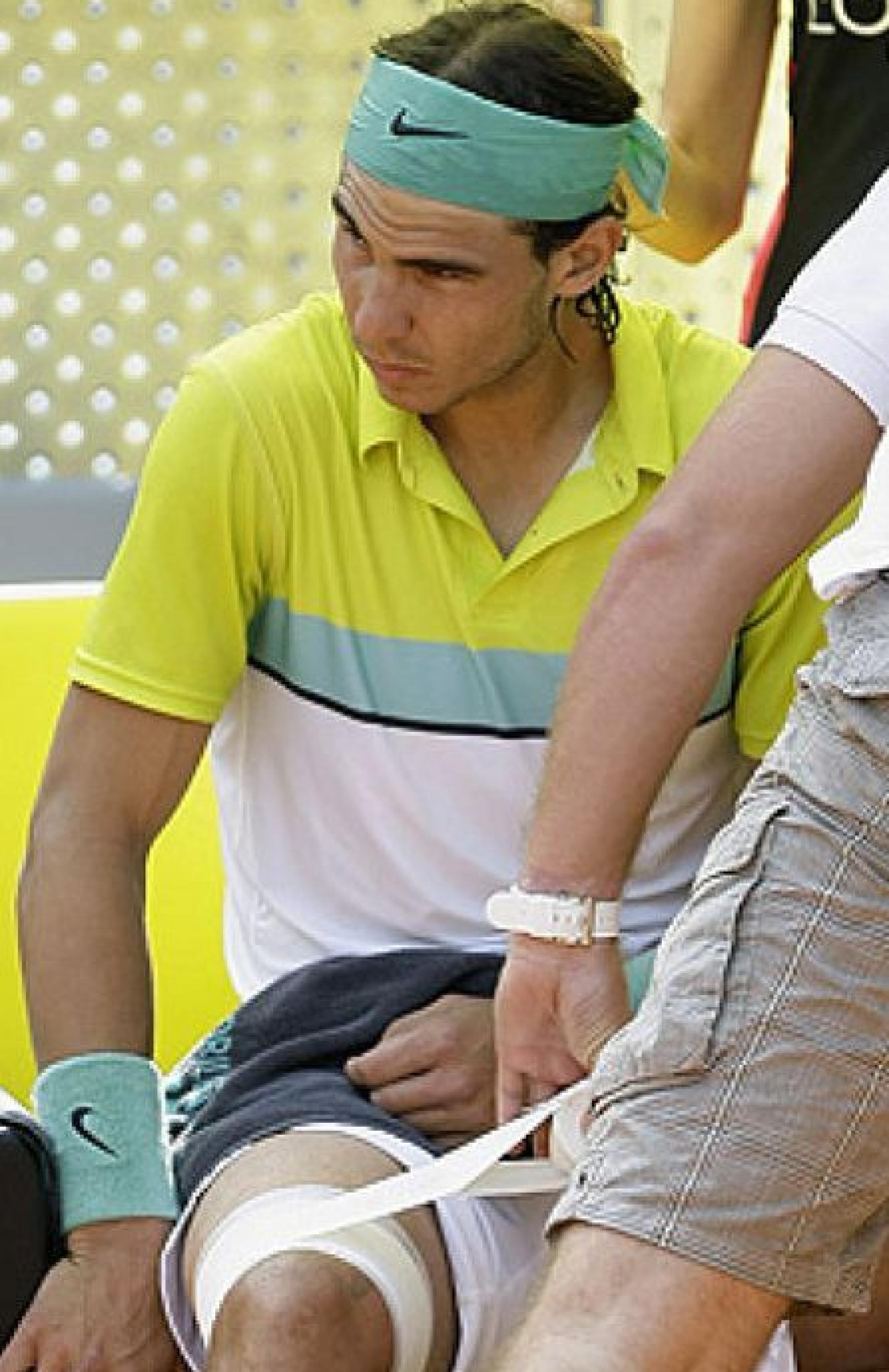 Nadal en un partido de tenis con las rodillas doloridas.