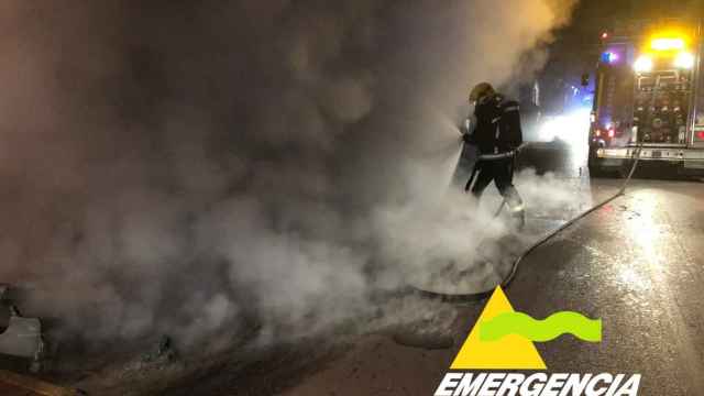 Un bombero tratando de apagar el fuego que ha calcinado tres contenedores en Tomelloso. Foto: SCIS Ciudad Real.