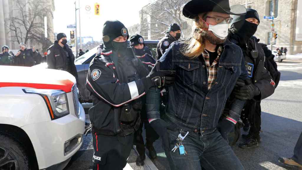 Canadian police detain a protester in Toronto, Ontario, Canada.