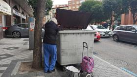 Una mujer busca comida en un contenedor en Valladolid.