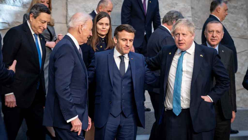 Macron embraced Johnson and Biden, along with Draghi and Erdogan, at NATO headquarters in Brussels.