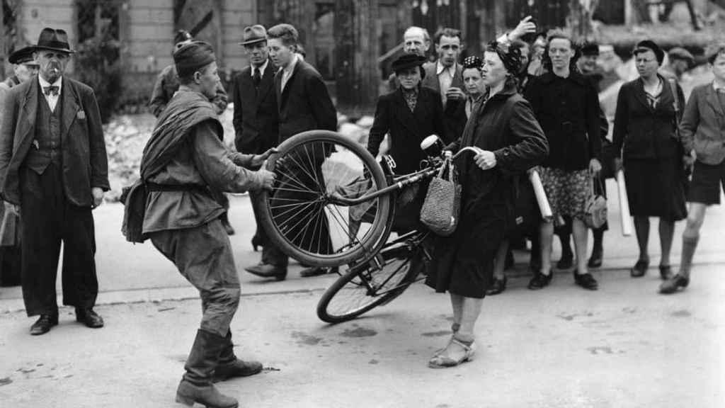 Un soldado soviético increpa a una mujer alemana en la toma de Berlín.
