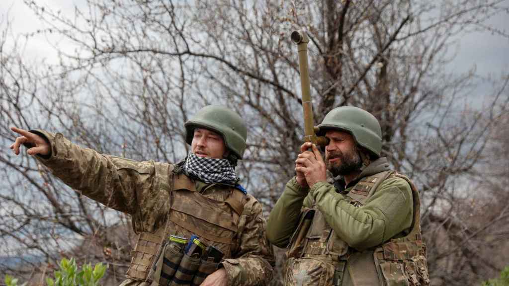 Dos soldados ucranianos miran al horizonte, región del Donbás, Ucrania.