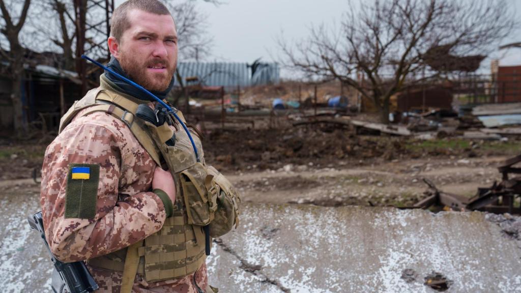 A Ukrainian soldier stands guard in a village near Kherson.