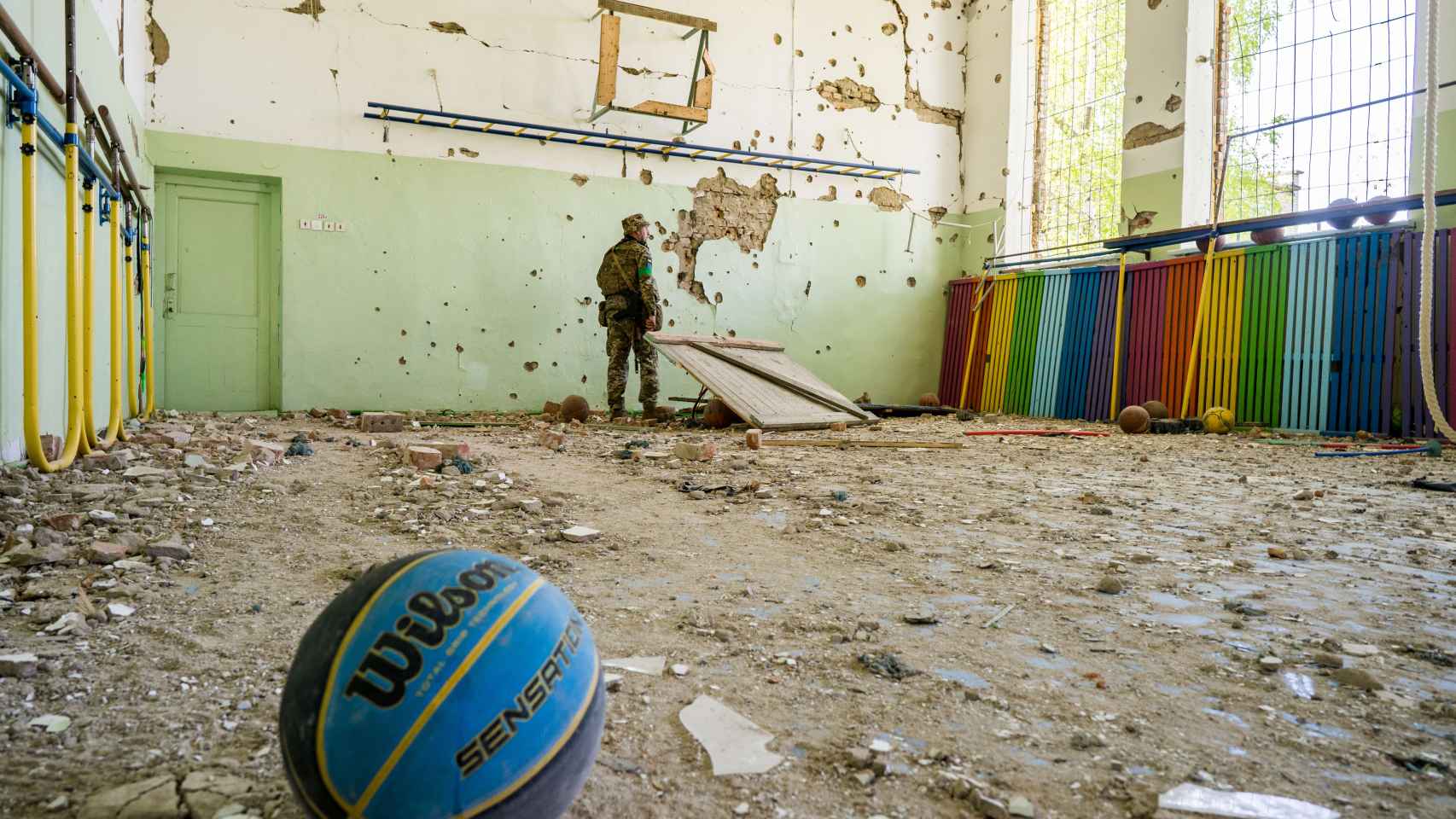 Un soldado inspecciona un colegio bombardeado en un pueblo cercano a Jersón.