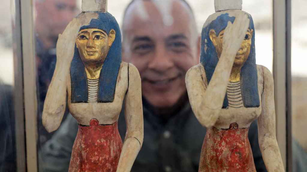 Las figurillas de madera de Isis y Neftis, observadas por Mustafa Waziri.