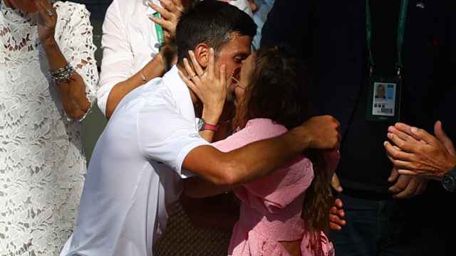 Beso entre Novak y Jelena Djokovic después de la victoria en Wimbledon 2022 del tenista serbio
