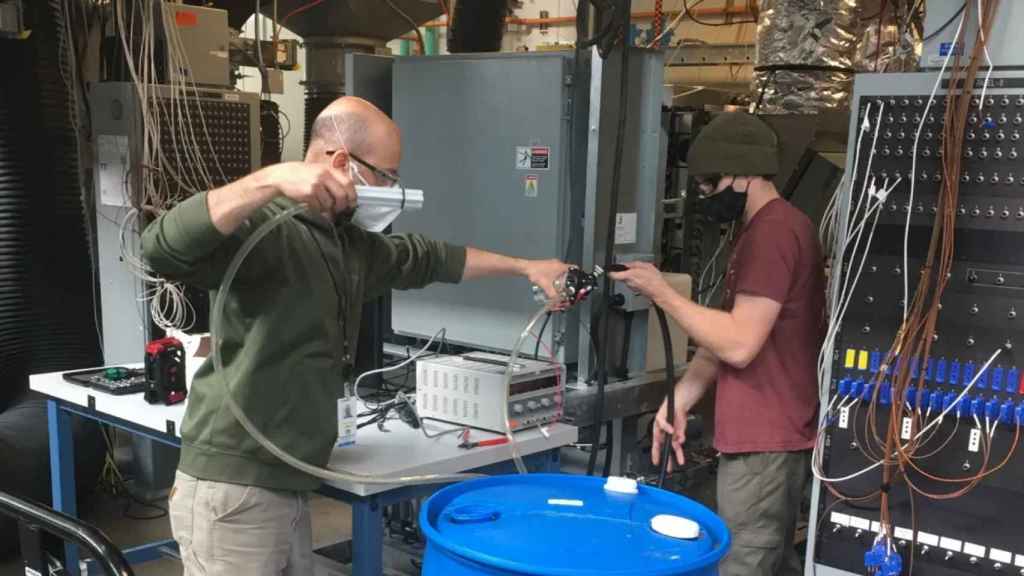 Blue Frontier technicians testing a prototype of their air conditioner