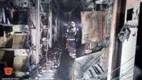 Un bombero trabaja en el interior de la nave calcinada. Foto: CPEIS Toledo.