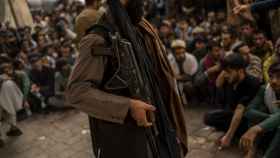 Un talibán controla a un grupo de gente que espera para sacar dinero en efectivo en septiembre de 2021.