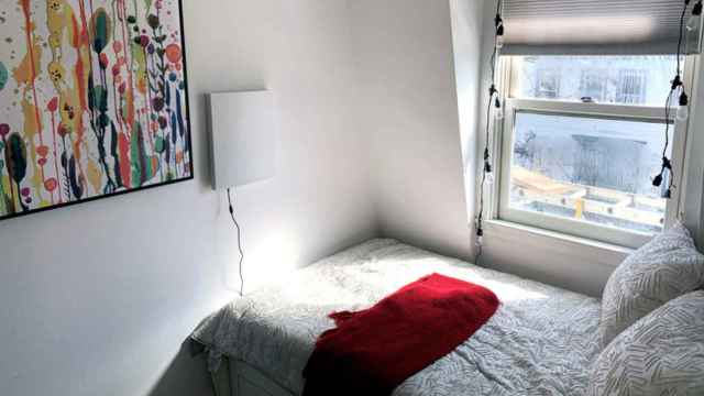 El dispositivo de color blanco con la IA colocado en la pared de un dormitorio.
