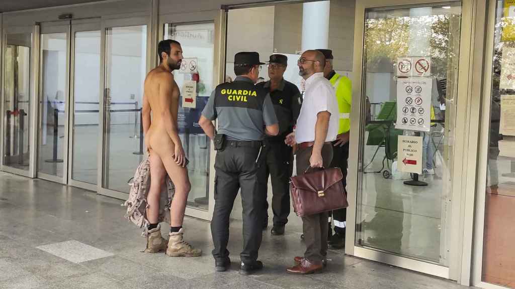 Alejandro Colomar intentando acceder desnudo al juzgado, este martes en Valencia.