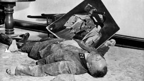 El comandante del batallón de la Volksstrum, Walter Dönicke, muerto por envenenamiento junto a un retrato desgarrado de Hitler. / NARA