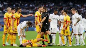 Melero López, el árbitro del partido, rodeado de jugadores del Real Madrid y del Girona.