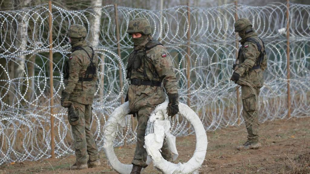 Polish soldiers install barbed wire along the Polish border with the Russian exclave of Kaliningrad.