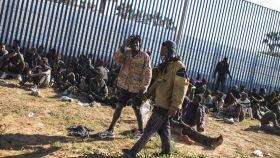 Varios migrantes africanos son atendidos en Melilla después de saltar la valla el 24 de junio